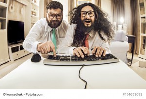 Two nerdy guys working with a computer